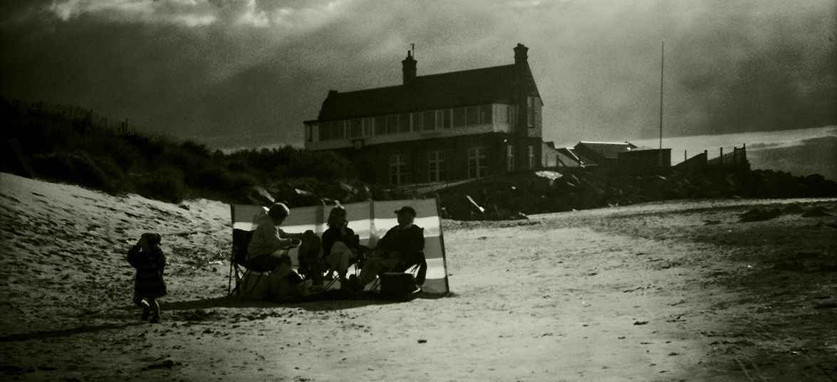 Family on a beach at Brancaster beach, Norfolk, UK. Image by photographer Richard Flint.