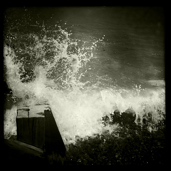 Book Beginnings. A wave hits the shore at Sheringham, Norfolk, UK