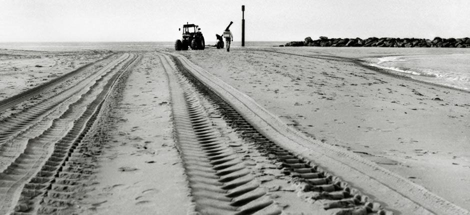 tractor tyre tracks in the sand on a beach at Sea palling, Norfolk - image by photographer Richard Flint