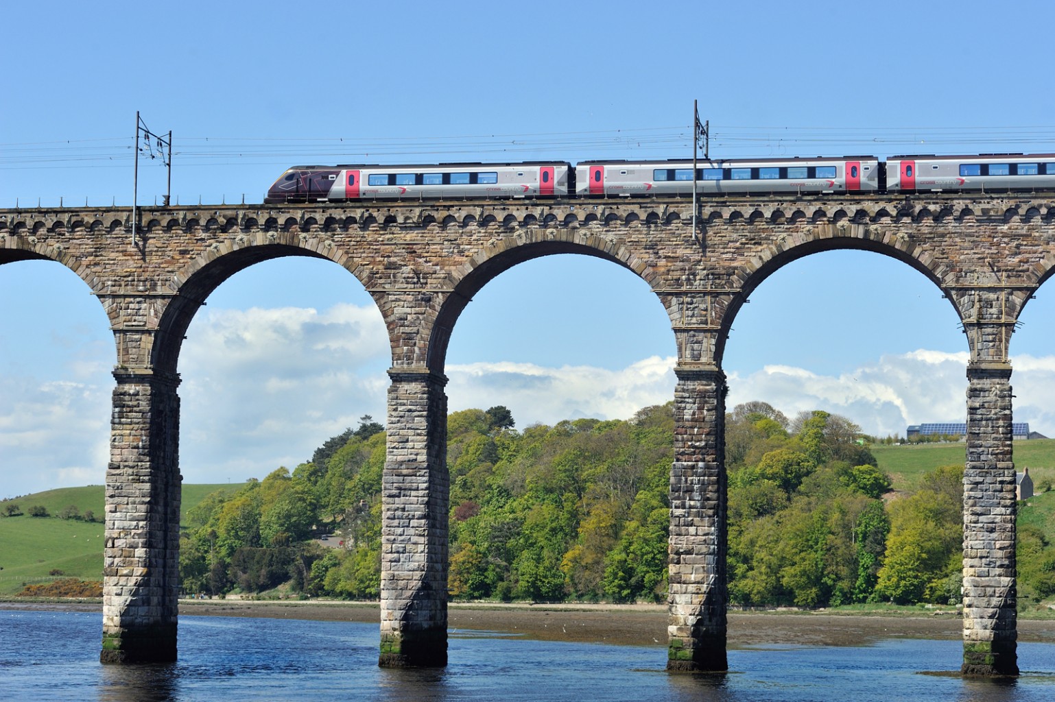 East Coast railway train crossing the Royal Border Bridge at Berwick Upon Tweed in Northumberland.
